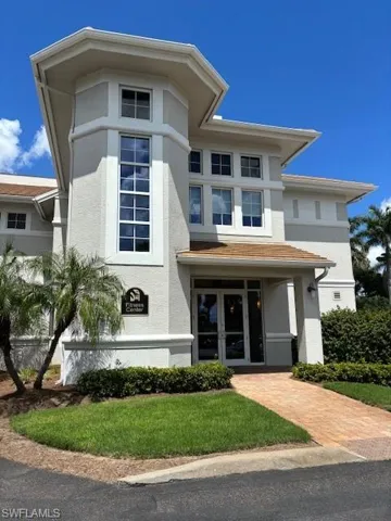 View of front of house with stucco siding and french doors