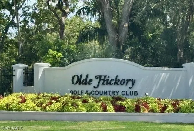 Community sign with view of wooded area