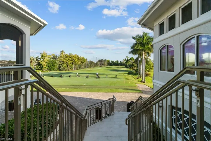 View of patio with outdoor dining area and ceiling fan