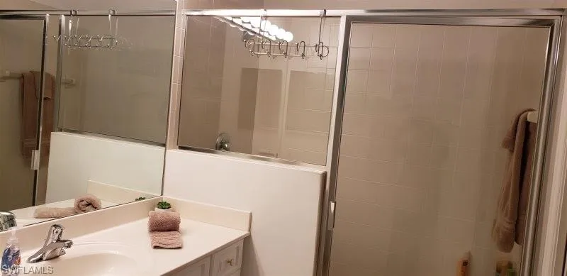 Bathroom featuring a shower stall and vanity