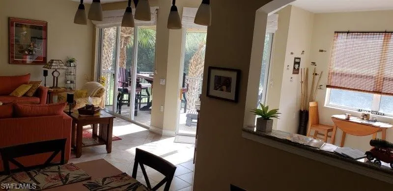 Living area with arched walkways and light tile patterned flooring