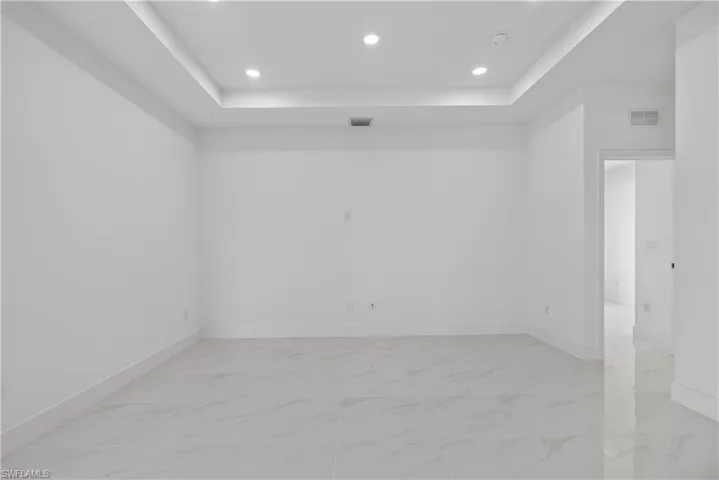 Recessed lighting illuminates a tray ceiling