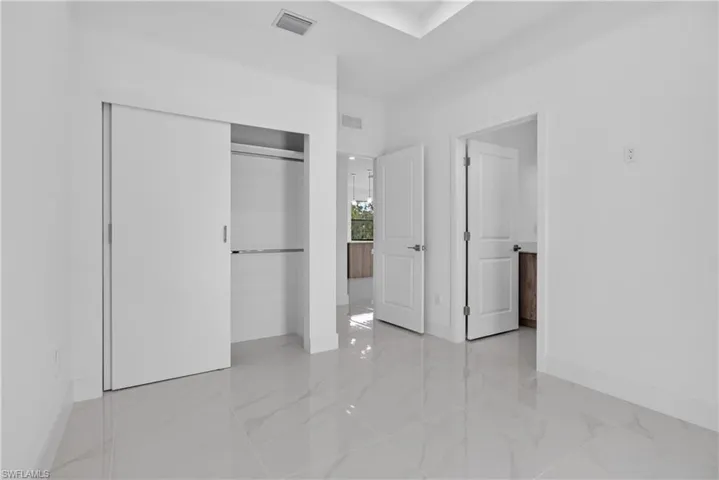 Bright interior featuring white walls and white baseboards