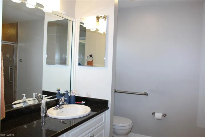 Mater Bathroom featuring vanity, toilet, and an enclosed shower