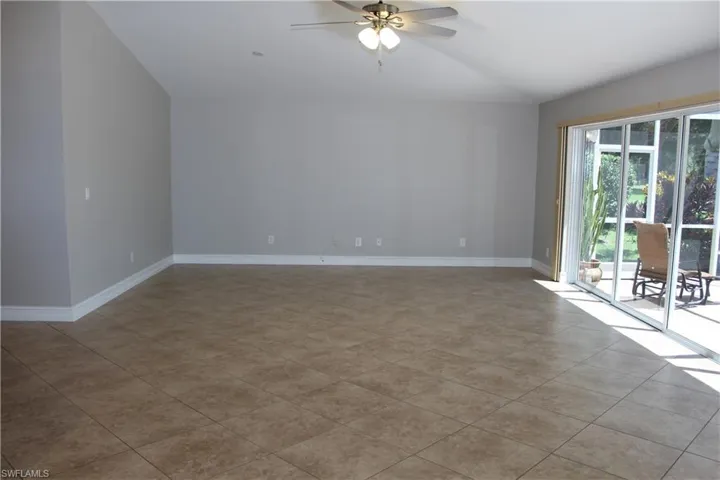 Spare room featuring lofted ceiling and ceiling fan