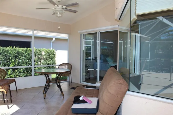 Sunroom / solarium with lofted ceiling and a ceiling fan