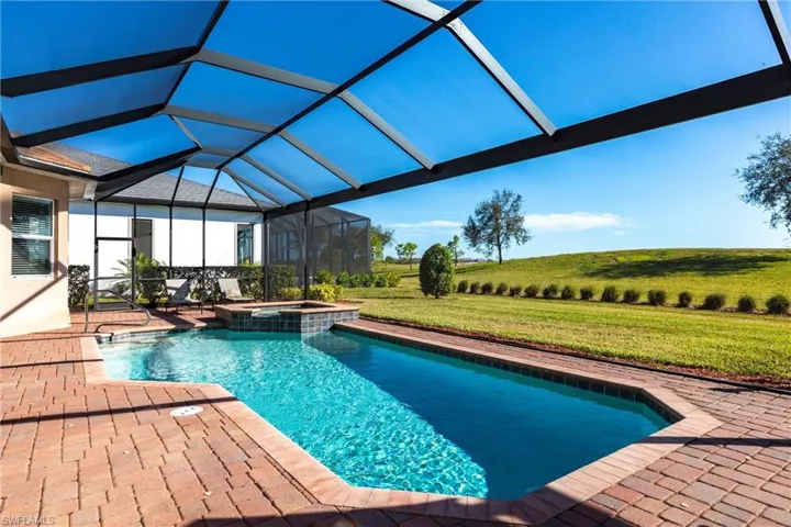 Pool/spa with view of the #9 fairway through the picture window screen
