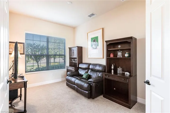 Bedroom with double doors that is used as a den/office.