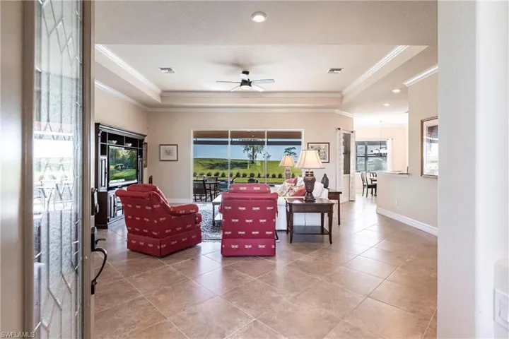 Tiled great room with tray ceiling and crown molding.