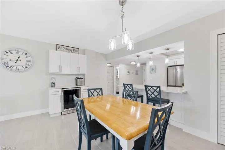 Dining area featuring wine cooler and light tile patterned floors