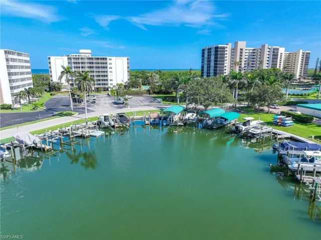 Drone / aerial view of a nearby body of water and apartment complex