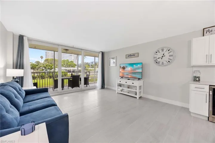 Living room with a wall of windows and beverage cooler