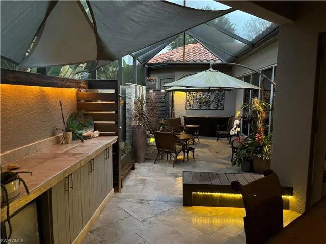 View of patio featuring a lanai