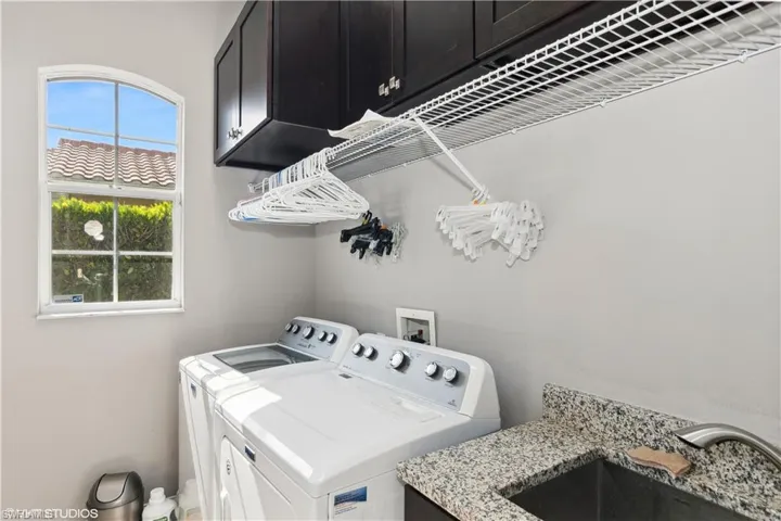 Clothes washing area with hookup for a washing machine, independent washer and dryer, sink, and cabinets