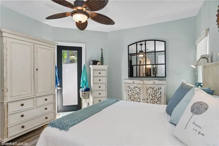Bedroom featuring dark wood-type flooring and ceiling fan