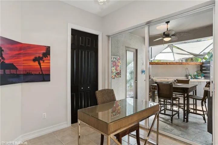 Tiled dining room featuring ceiling fan