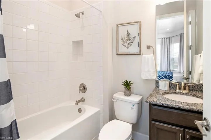 Bathroom with vanity and shower / tub combo
