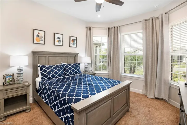 Bedroom featuring light colored carpet and ceiling fan