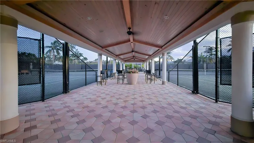 Sunroom featuring a patio area and beam ceiling
