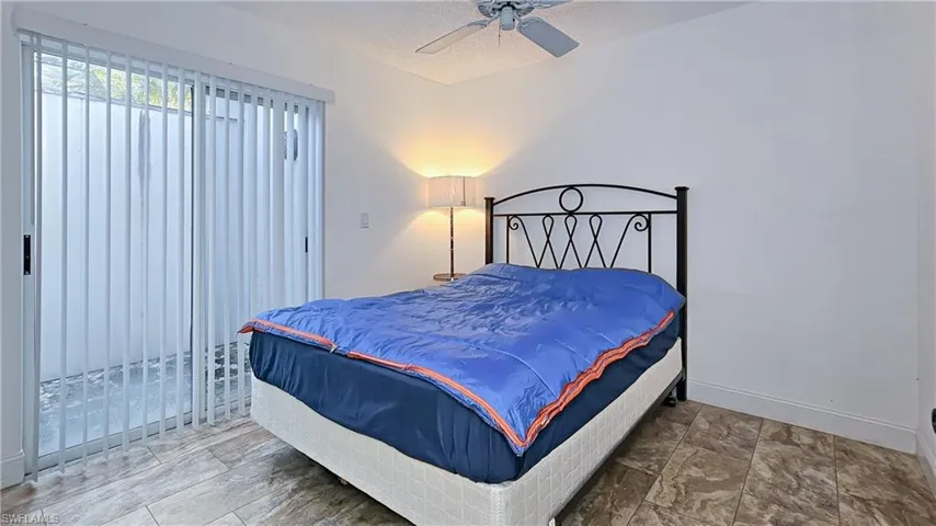 Bedroom featuring ceiling fan and a textured ceiling