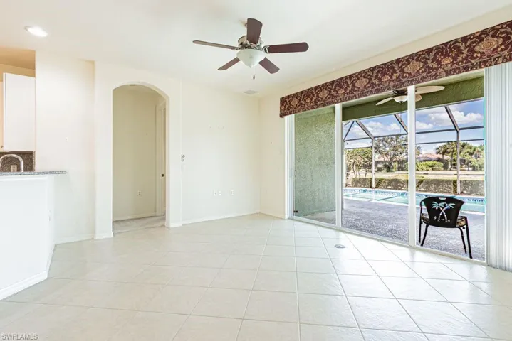 Spare room with a sunroom, a ceiling fan, light tile patterned floors, and recessed lighting