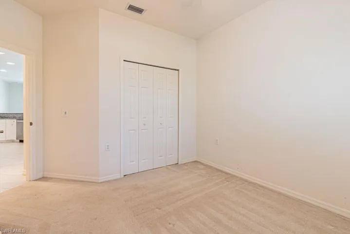 Unfurnished bedroom featuring light carpet, a closet, a ceiling fan, and recessed lighting