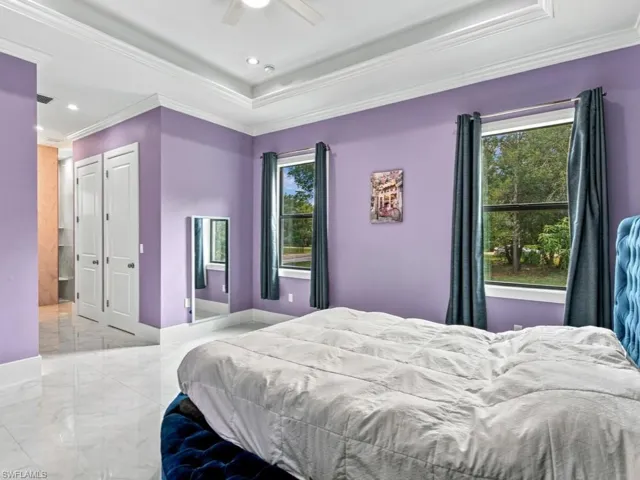 Tray ceiling with recessed lighting, tile flooring, two solid-core interior doors, and dual pane windows with casing
