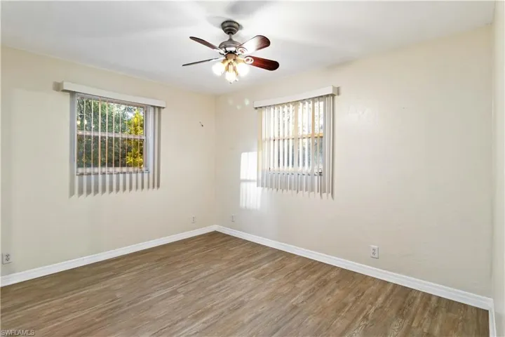Unfurnished room featuring wood-type flooring and ceiling fan