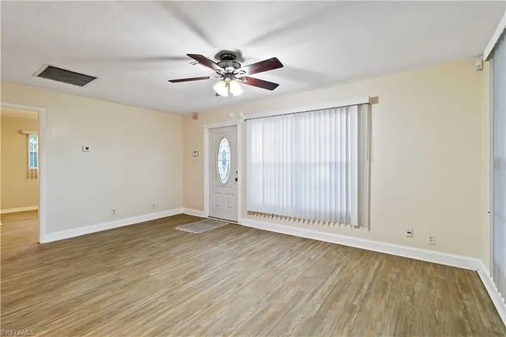 Foyer with ceiling fan and light hardwood / wood-style flooring
