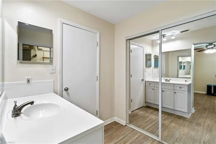Bathroom featuring hardwood / wood-style floors, vanity, and ceiling fan