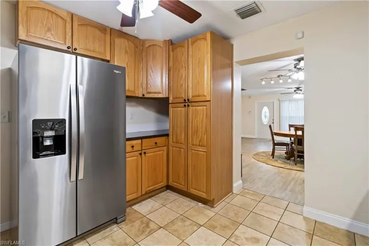 Kitchen featuring light hardwood / wood-style floors and stainless steel refrigerator with ice dispenser
