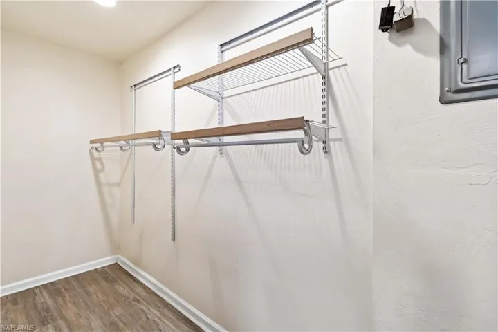 Spacious closet featuring wood-type flooring and electric panel