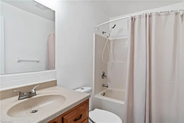Full bathroom featuring vanity, toilet, and shower / tub combo