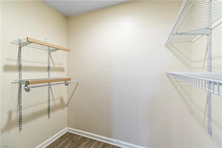 Spacious closet featuring hardwood / wood-style flooring