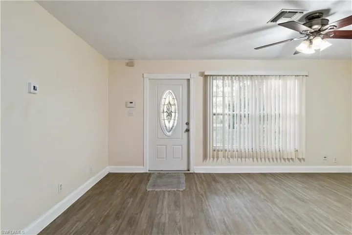 Foyer with wood-type flooring and ceiling fan