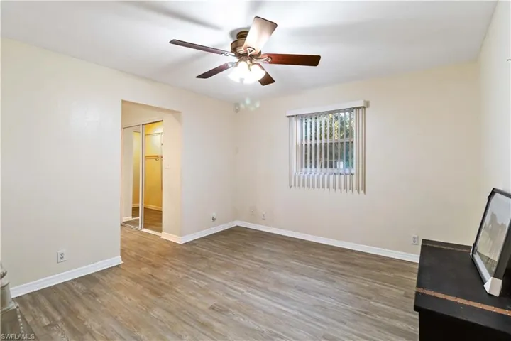 Unfurnished living room featuring hardwood / wood-style flooring and ceiling fan