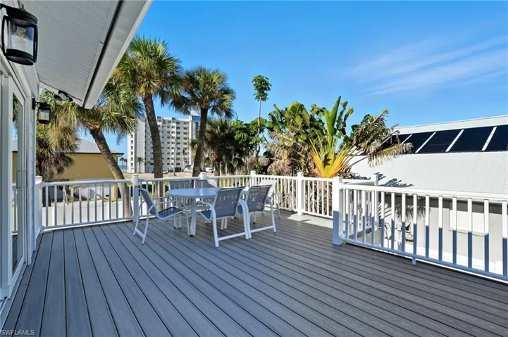 Wooden terrace featuring outdoor dining space - Virtually Edited Image
