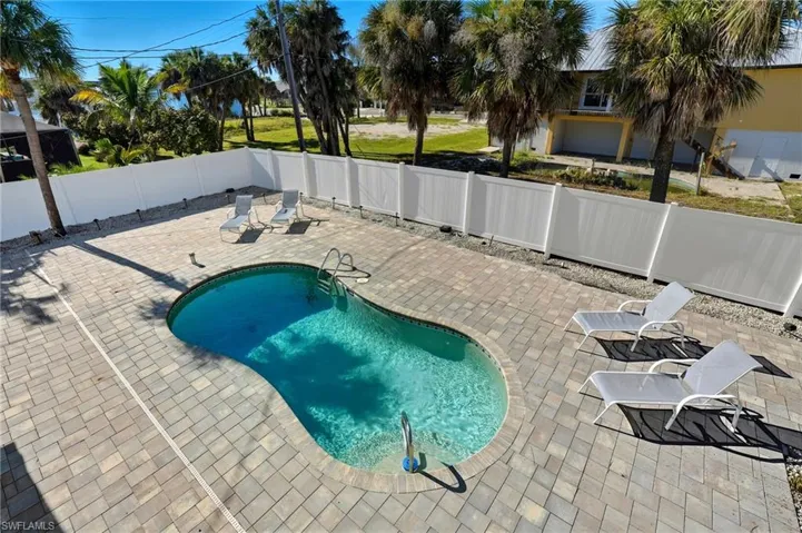 View of pool featuring a patio and a fenced backyard - Virtually Edited Image