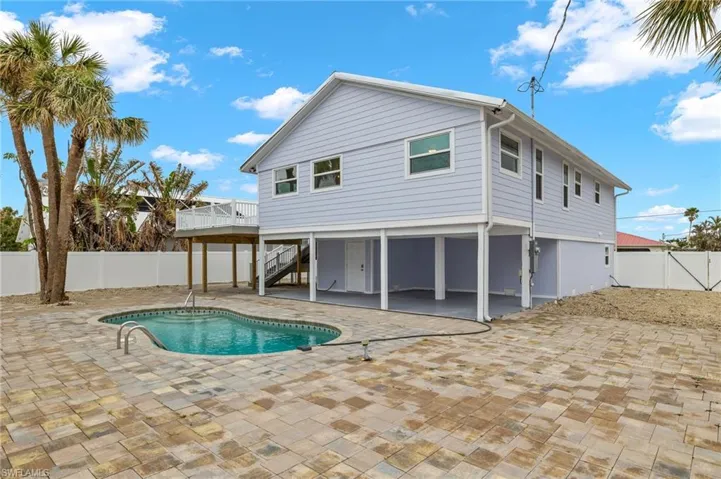 Enjoy outdoor living with this pool and patio area - Virtually Edited Image