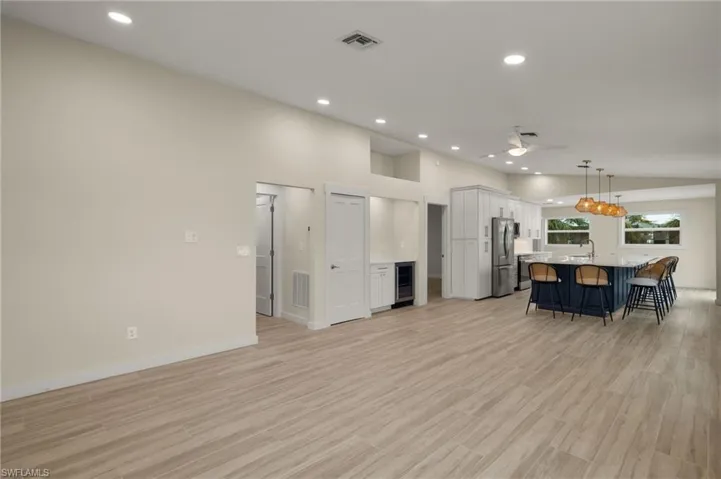 Spacious open-concept living area flowing into the kitchen - Virtually Edited Image