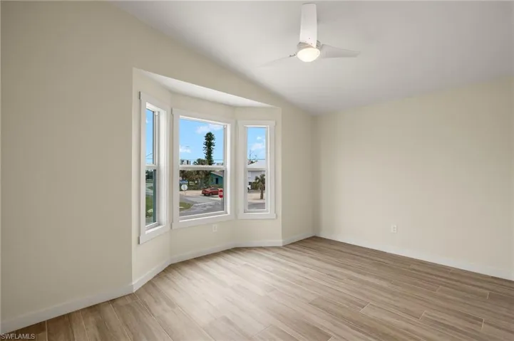 Spacious room with a bay window offering natural light - Virtually Edited Image