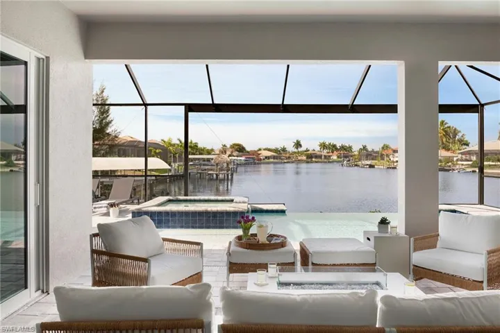 View of patio / terrace with glass enclosure, an outdoor living space, and a water view