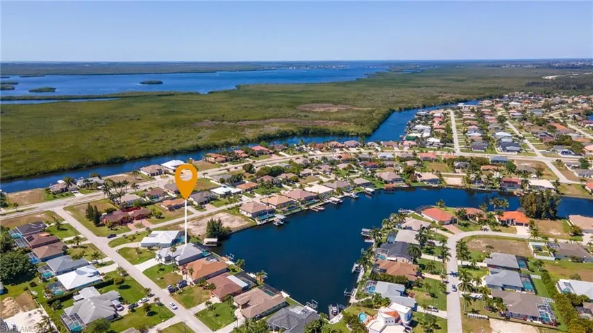 Aerial perspective of suburban area featuring a large body of water