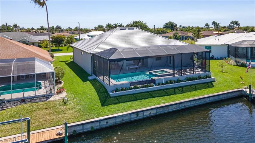 Rear view of property with a residential view, a patio, and a water view