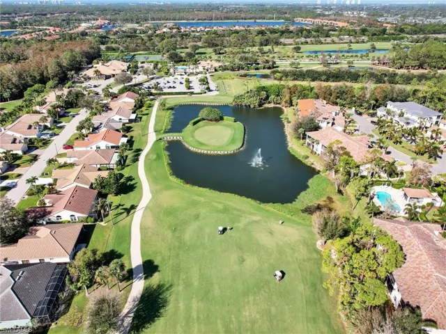 Birds eye view of property featuring a water view, view of golf course, and a residential view