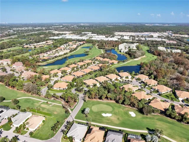 Birds eye view of property featuring a water view, a residential view, and golf course view