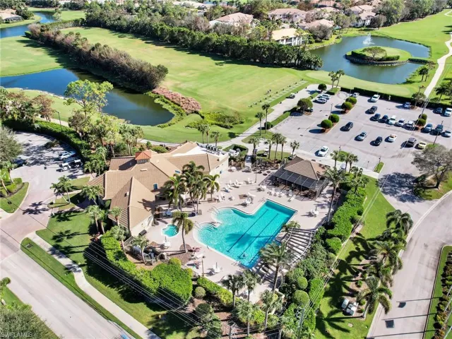 Birds eye view of property with a water view and view of golf course