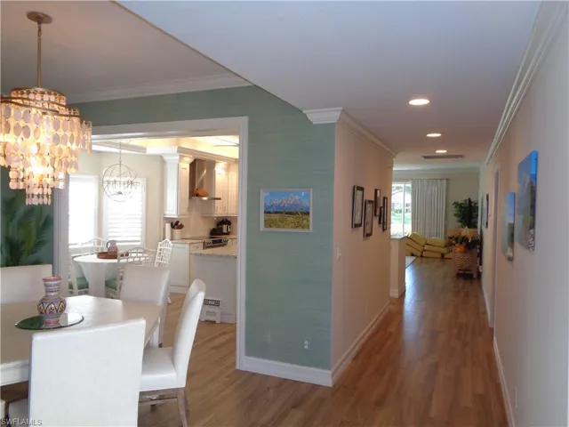 Dining room featuring crown molding, wood finished floors, and a chandelier