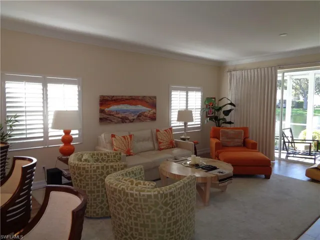 Living room featuring crown molding and baseboards