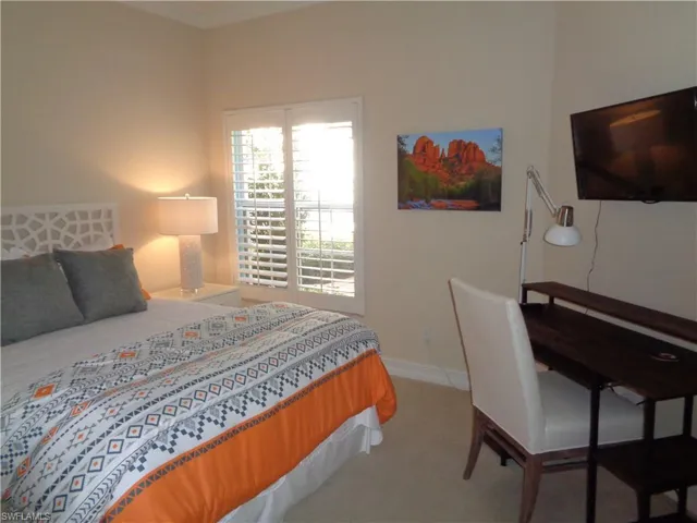 Bedroom featuring carpet floors and crown molding